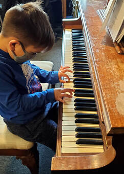 Our student playing piano during his lesson. Our qualified instructors help you to learn to play piano