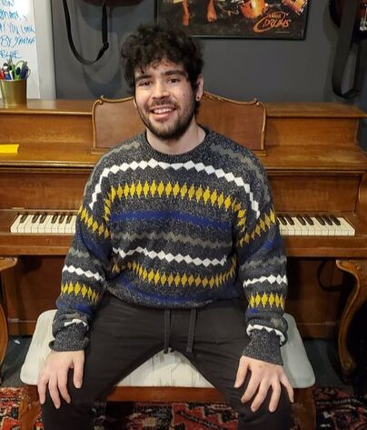 Picture of Owen in between piano and percussion lessons. Owen teaches piano lessons, drum set lessons, percussion lessons, and has a jazz performance degree from Elmhurst University. 